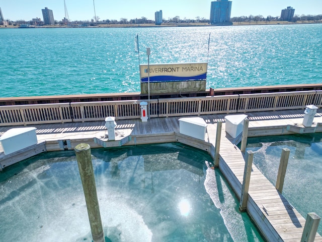 view of dock featuring a city view and a water view