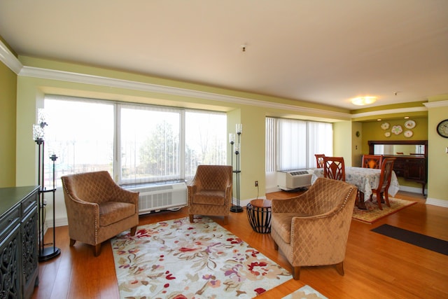 living area featuring baseboards and wood finished floors