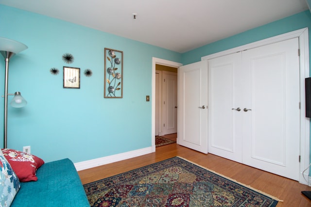 interior space with wood finished floors and baseboards