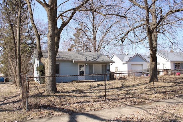 view of front of home with a fenced front yard and a chimney