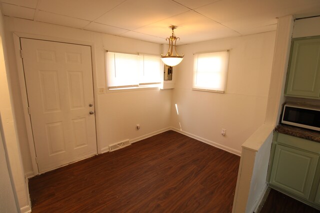 unfurnished dining area with visible vents, baseboards, and dark wood-style flooring