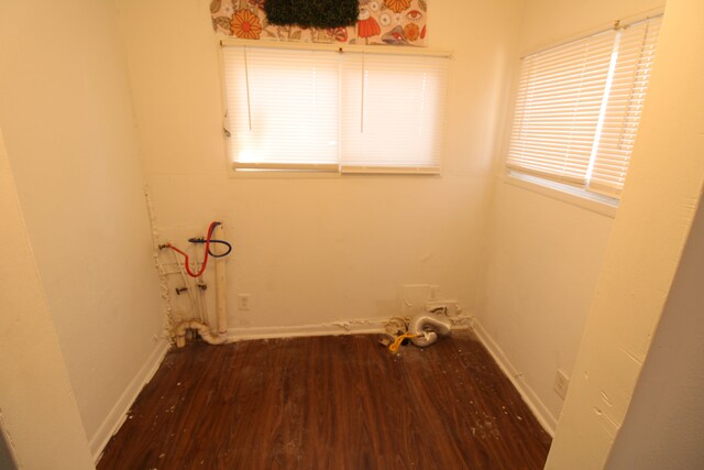 interior space featuring plenty of natural light, wood finished floors, and baseboards