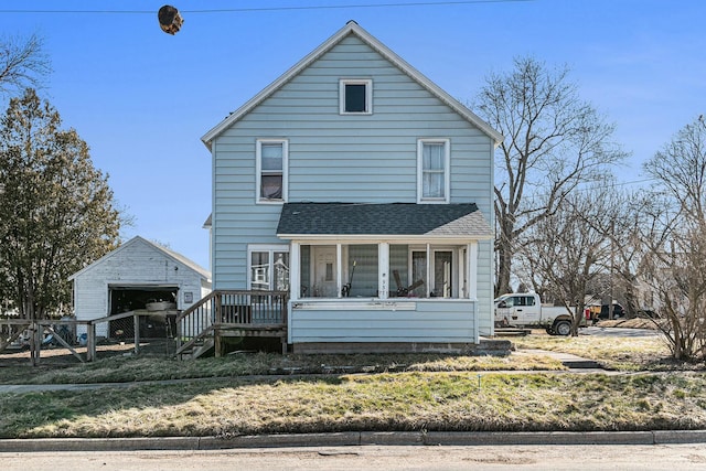 view of front of house featuring an outbuilding, fence, and a shingled roof