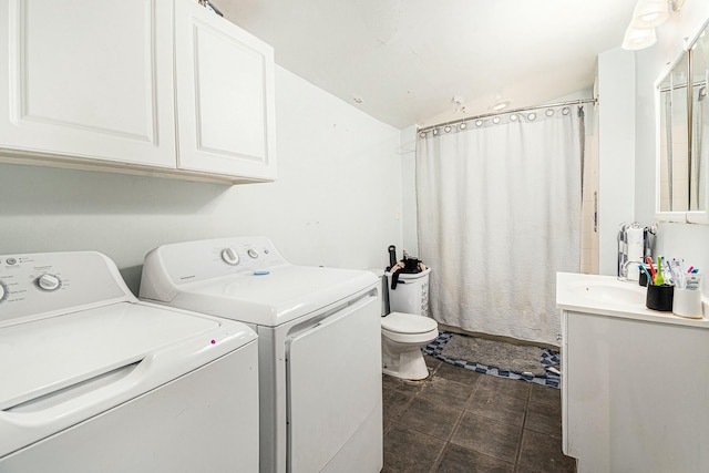 washroom featuring a sink, independent washer and dryer, and laundry area