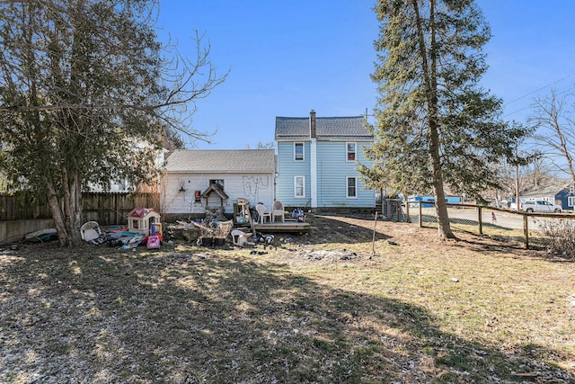 rear view of property with a deck and a fenced backyard