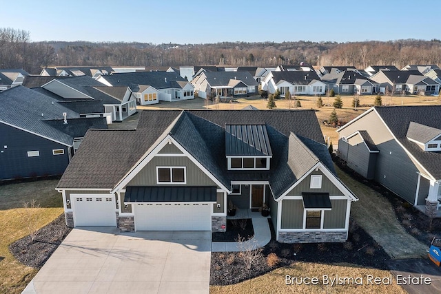 view of front of property featuring a residential view, stone siding, board and batten siding, and driveway