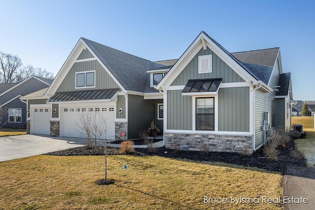 view of front of property with a standing seam roof, concrete driveway, stone siding, and metal roof