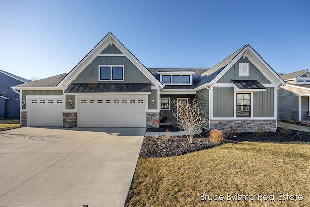 view of front of property with a standing seam roof, stone siding, board and batten siding, concrete driveway, and metal roof