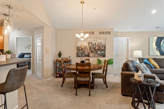 dining area with visible vents, light colored carpet, and a chandelier