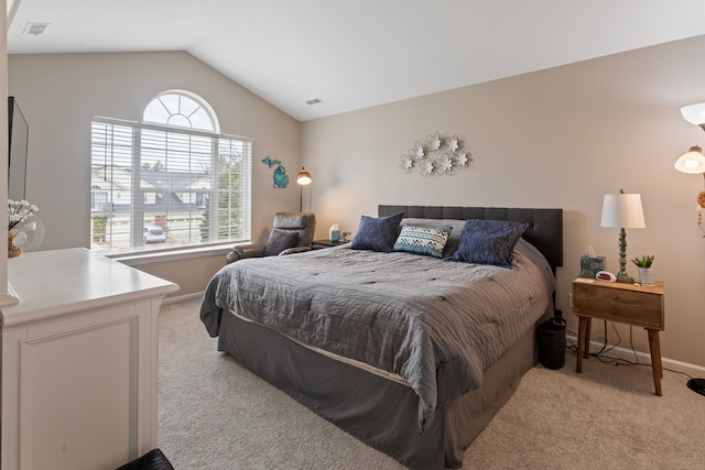 bedroom with light carpet, visible vents, baseboards, and lofted ceiling