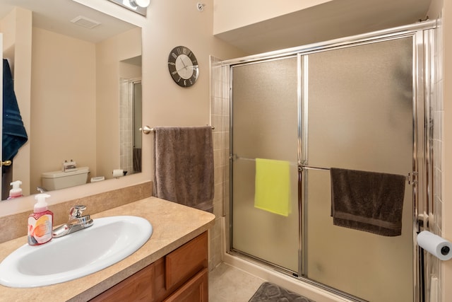 full bathroom with visible vents, toilet, a stall shower, tile patterned flooring, and vanity