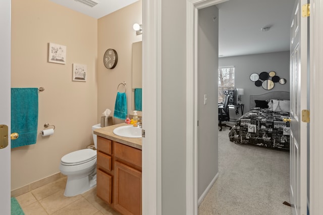 bathroom with vanity, baseboards, visible vents, tile patterned flooring, and toilet