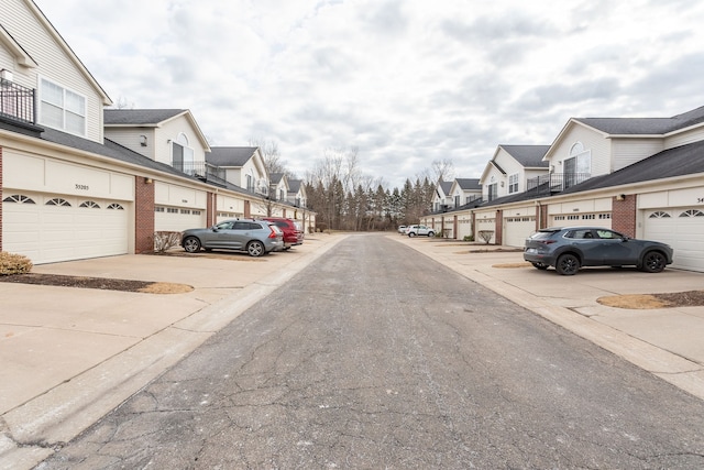 view of road with community garages and a residential view