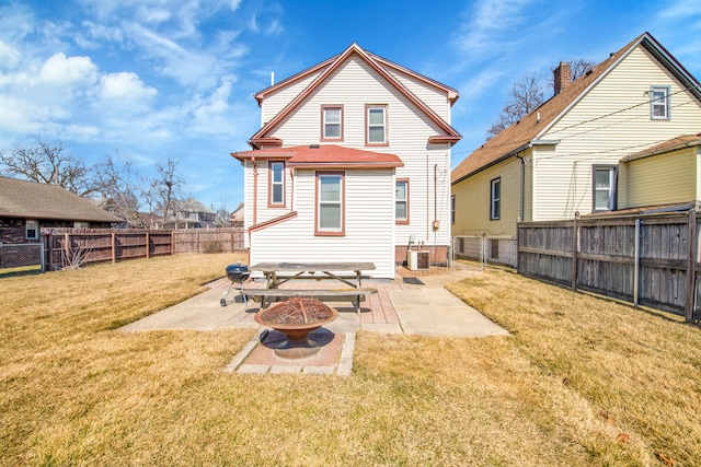 rear view of property with a patio, cooling unit, an outdoor fire pit, a fenced backyard, and a lawn