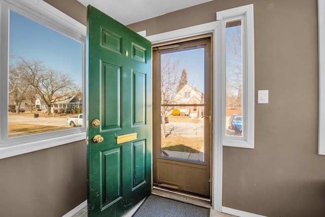 doorway featuring baseboards