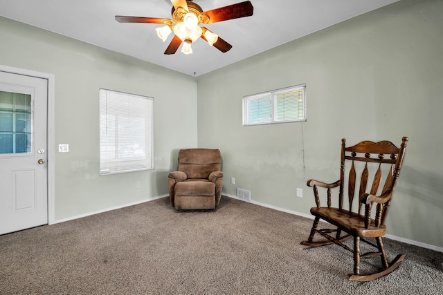 sitting room featuring a ceiling fan, visible vents, baseboards, and carpet floors