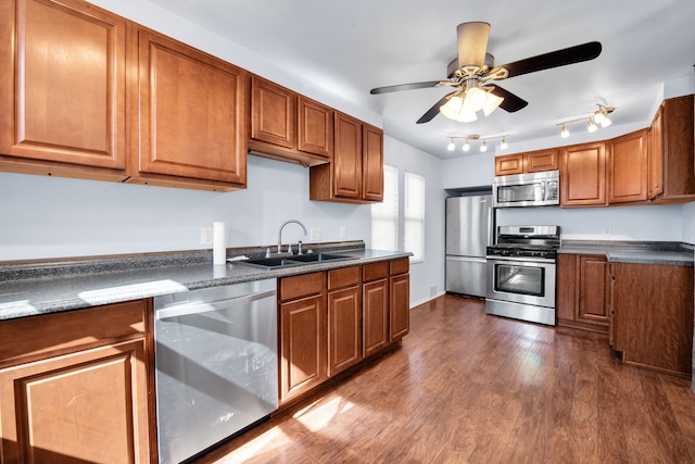 kitchen featuring dark countertops, appliances with stainless steel finishes, and brown cabinetry