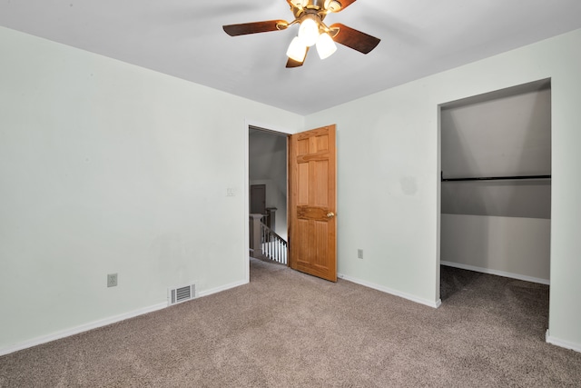 unfurnished bedroom featuring a ceiling fan, baseboards, visible vents, and carpet floors