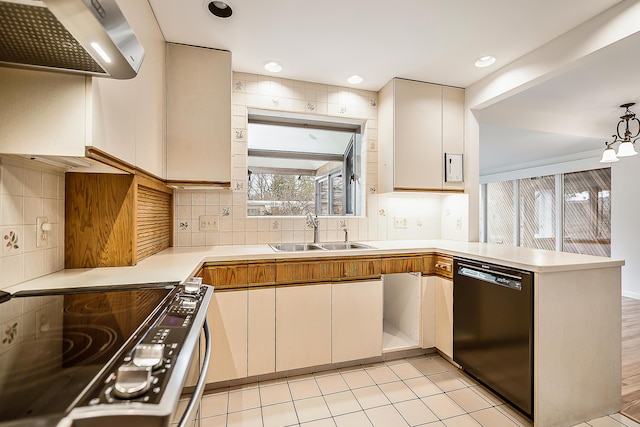 kitchen with a peninsula, electric range oven, a sink, light countertops, and black dishwasher