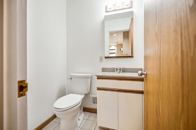 half bath featuring vanity, visible vents, baseboards, tile patterned flooring, and toilet