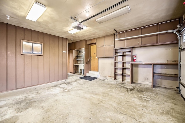 garage with wooden walls and a garage door opener