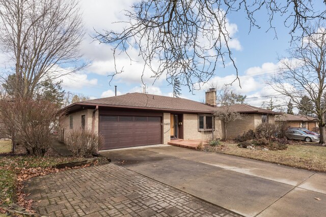 single story home with brick siding, concrete driveway, roof with shingles, a chimney, and a garage