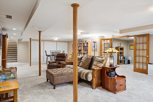 living area featuring recessed lighting, visible vents, light colored carpet, and stairs