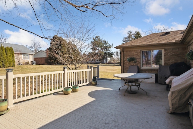 wooden deck featuring a yard