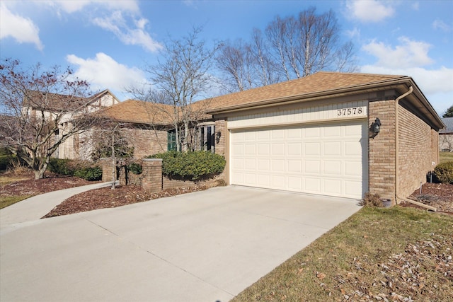 ranch-style home featuring an attached garage, brick siding, and driveway