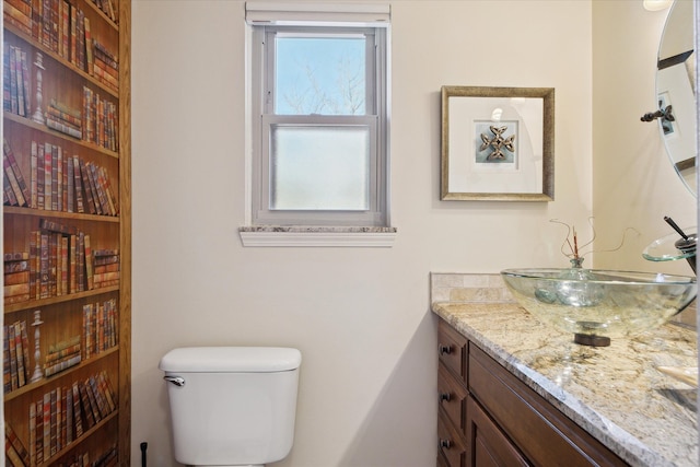 half bathroom with toilet and vanity