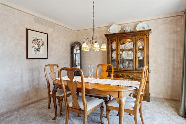 dining room featuring visible vents, light carpet, baseboards, and a chandelier