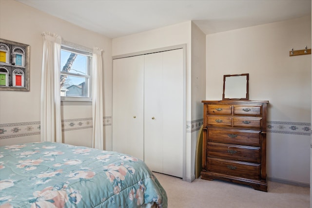 bedroom featuring light colored carpet and a closet