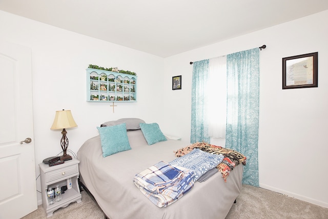 bedroom with baseboards and carpet floors