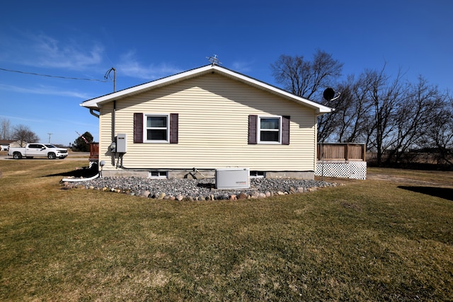 view of home's exterior featuring a yard and a deck