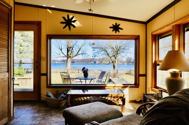 sunroom / solarium with a water view and vaulted ceiling