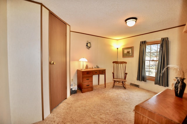 sitting room featuring a textured ceiling, visible vents, carpet floors, and ornamental molding