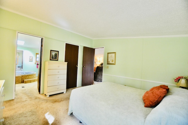 bedroom with carpet, ensuite bath, and crown molding