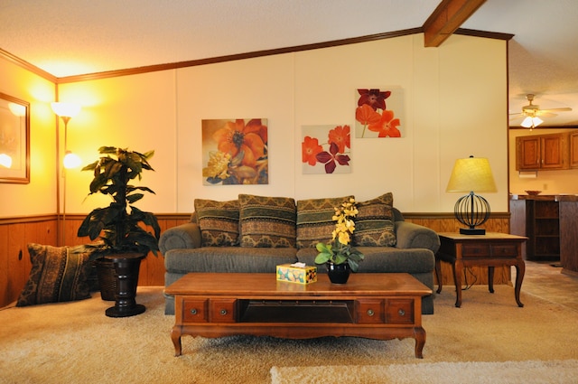 living area with wooden walls, a wainscoted wall, crown molding, and carpet