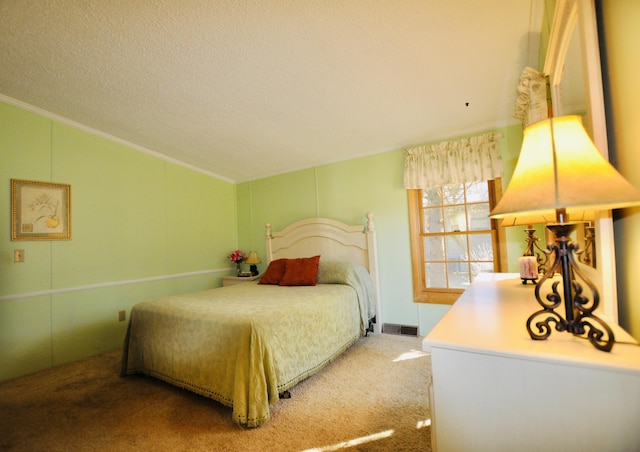 bedroom featuring visible vents, a textured ceiling, carpet, crown molding, and vaulted ceiling