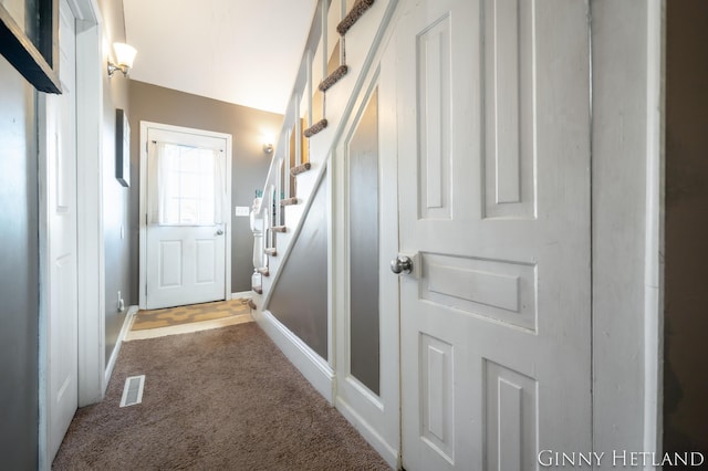 entryway featuring stairs, visible vents, and carpet floors