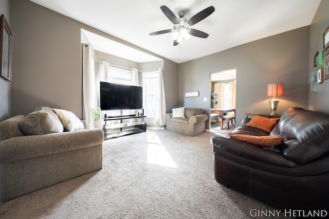 living area with carpet flooring and a ceiling fan