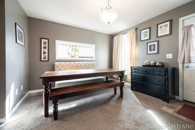 dining room featuring baseboards and carpet floors