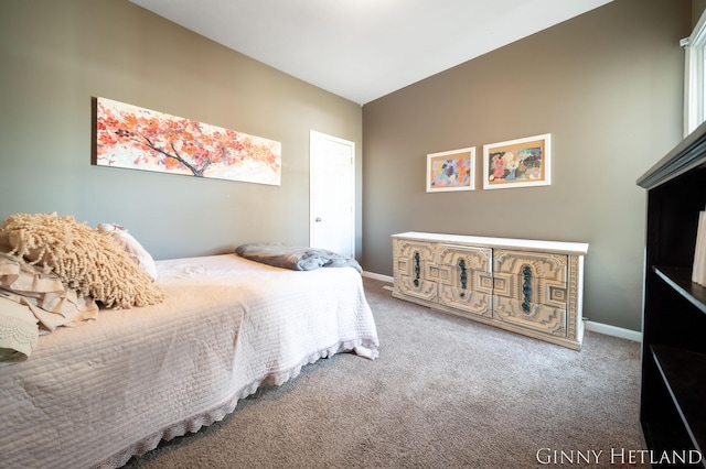 carpeted bedroom featuring vaulted ceiling and baseboards