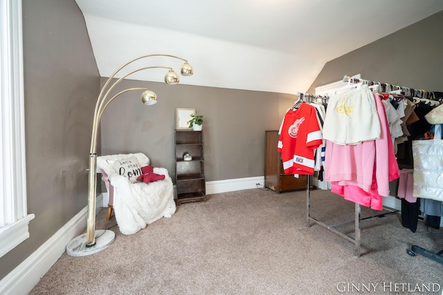 bedroom featuring lofted ceiling, baseboards, and carpet floors