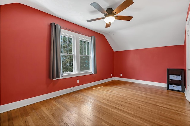 bonus room featuring vaulted ceiling, baseboards, light wood-type flooring, and ceiling fan