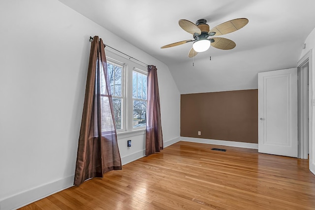 bonus room featuring visible vents, baseboards, light wood-type flooring, lofted ceiling, and a ceiling fan