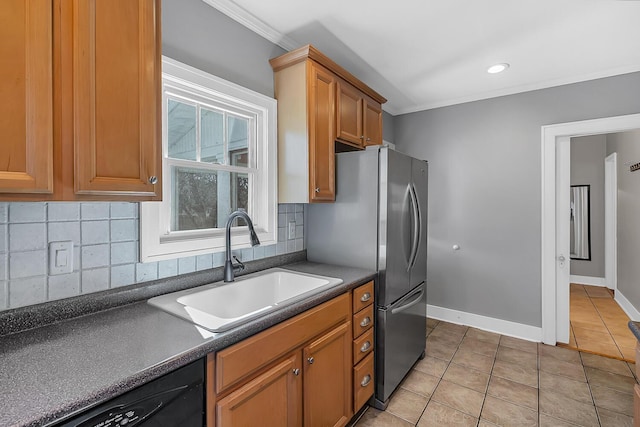 kitchen featuring dark countertops, dishwasher, light tile patterned floors, decorative backsplash, and a sink