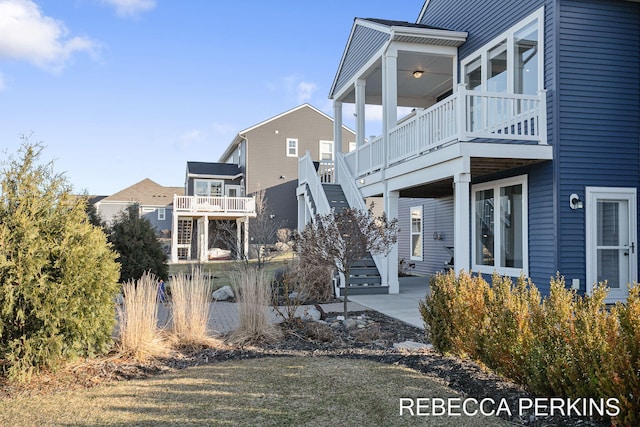 view of home's exterior featuring stairs and a patio