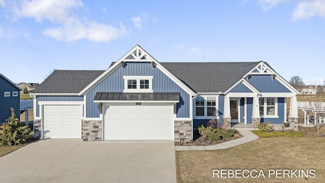 view of front facade with driveway, roof with shingles, a standing seam roof, a garage, and metal roof