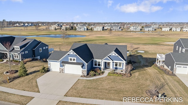 bird's eye view featuring a residential view and a water view